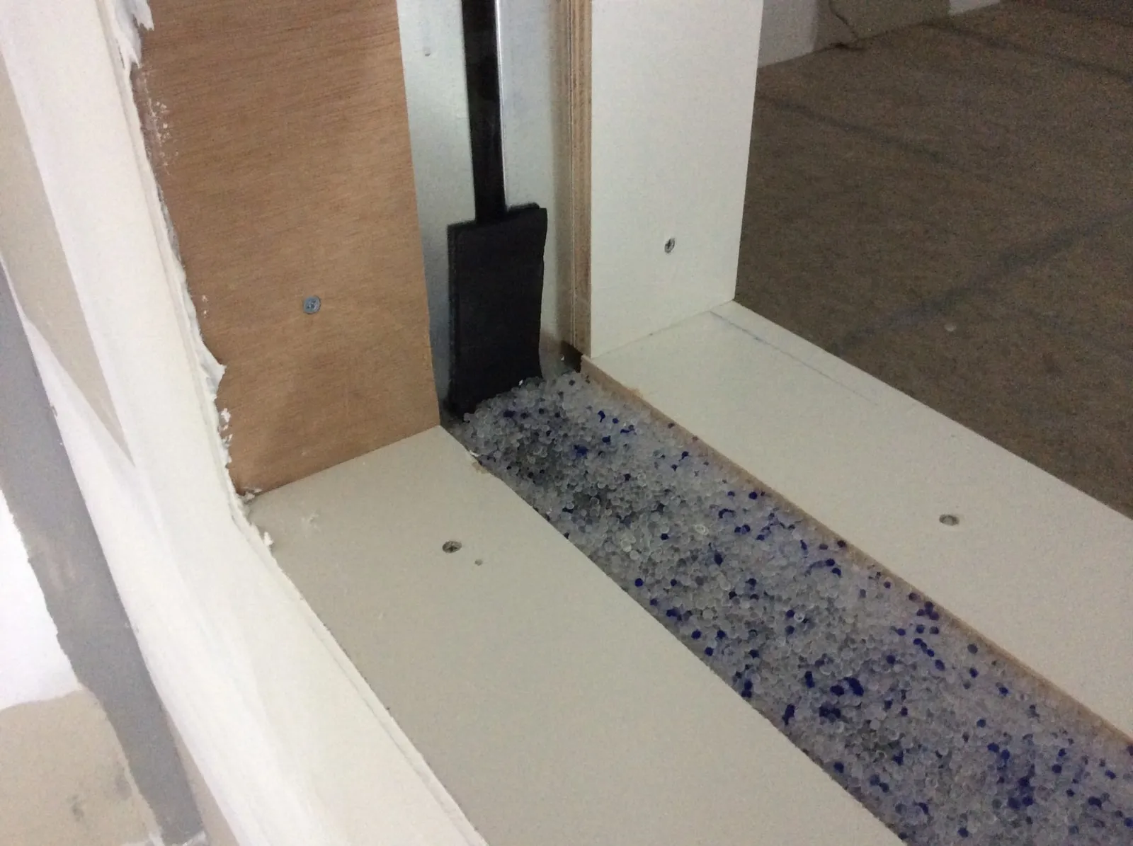 Under Construction: Inside look at the internals of a custom 2 pane recording studio window. Blue and white pellets are color-indicating silica gel. Under Construction: Inside look at the internals of a custom 2 pane recording studio window. Blue and white pellets are color-indicating silica gel.